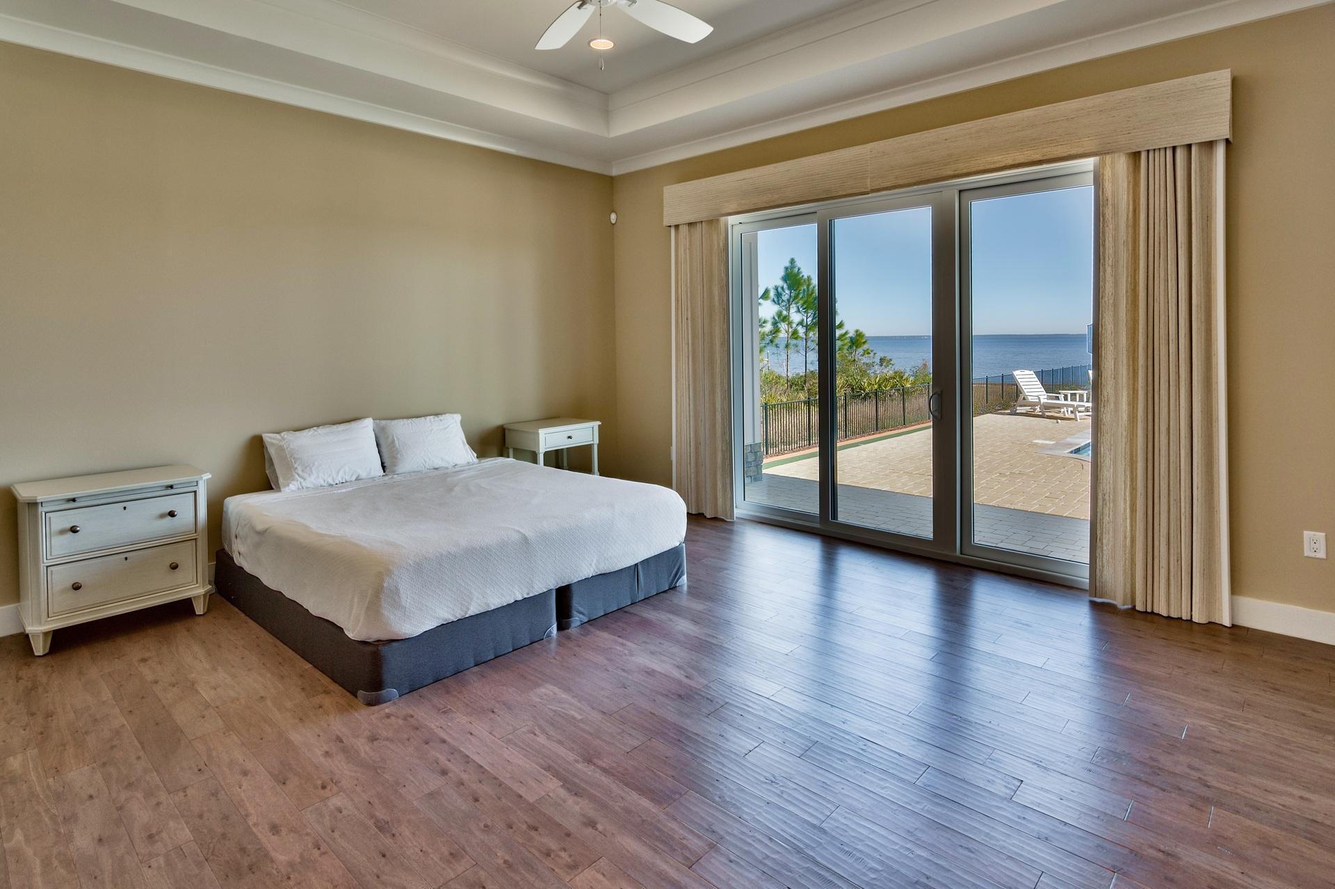 1591 Driftwood Point Road Santa Rosa Beach, FL 32459 - Photo 20 of 50 a spacious bedroom with a bed and wooden floor