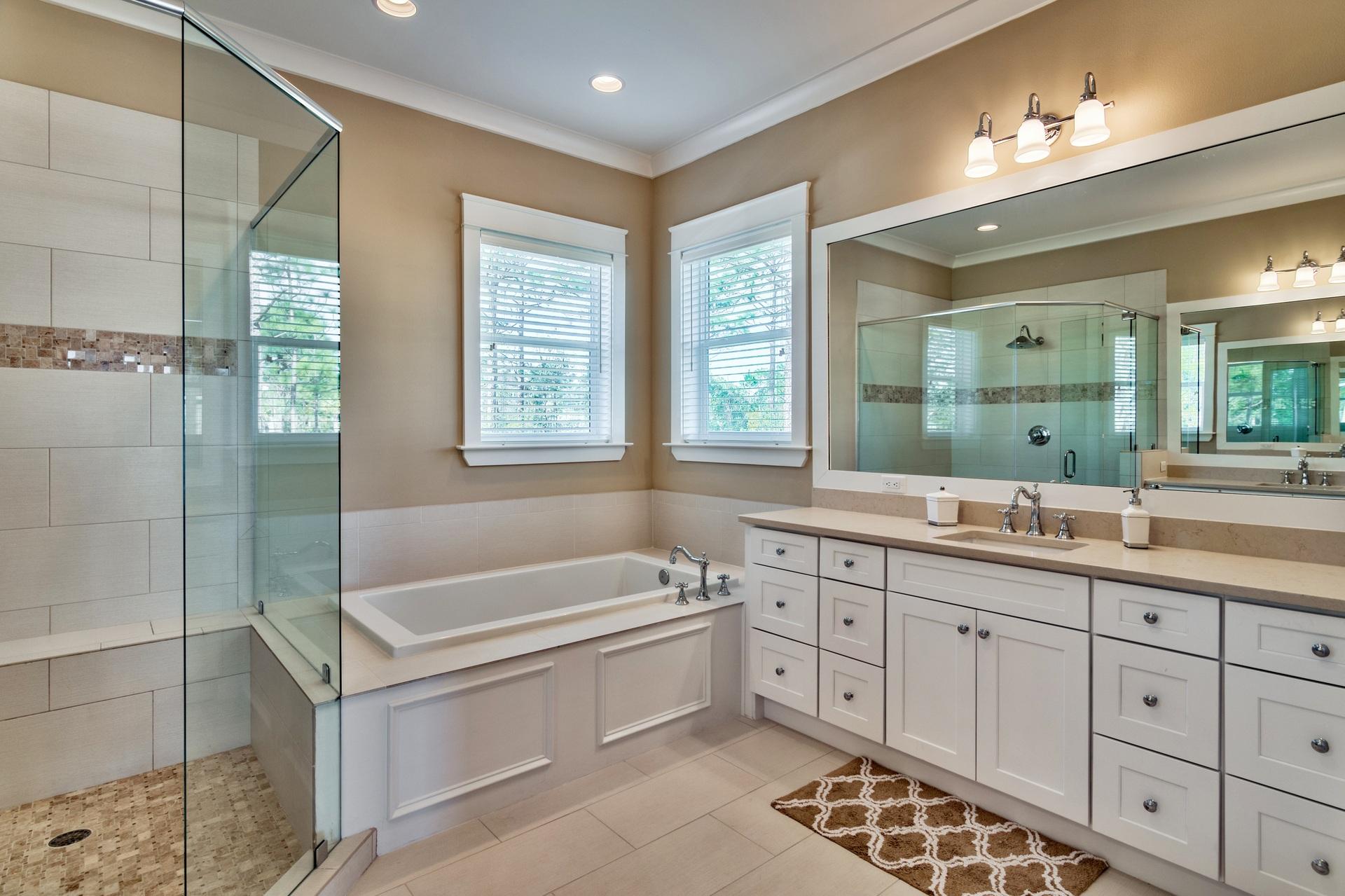 1591 Driftwood Point Road Santa Rosa Beach, FL 32459 - Photo 23 of 50 a bathroom with a double vanity sink large mirror and a bathtub