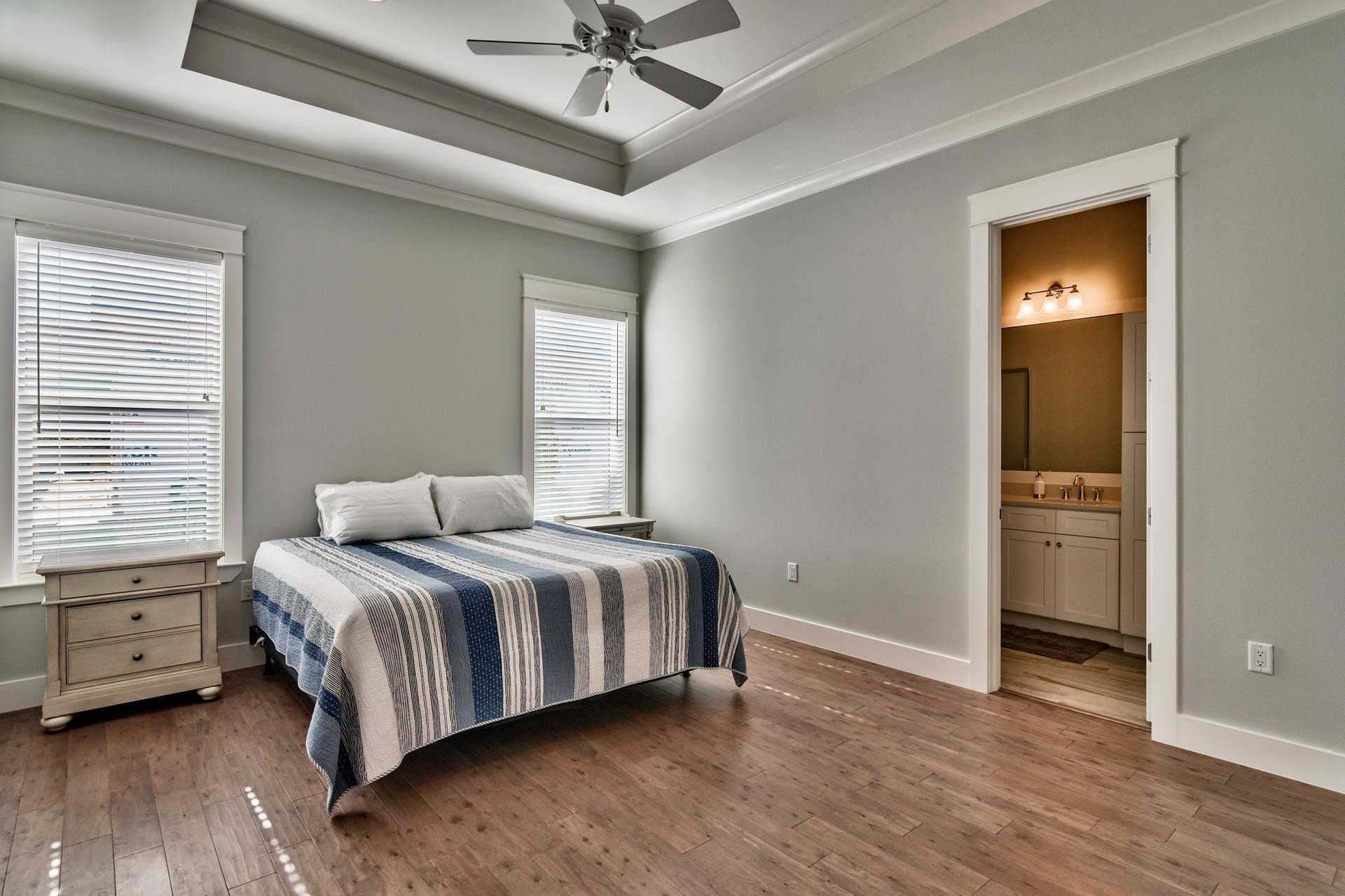 1591 Driftwood Point Road Santa Rosa Beach, FL 32459 - Photo 25 of 50 a bedroom with a bed and a chandelier