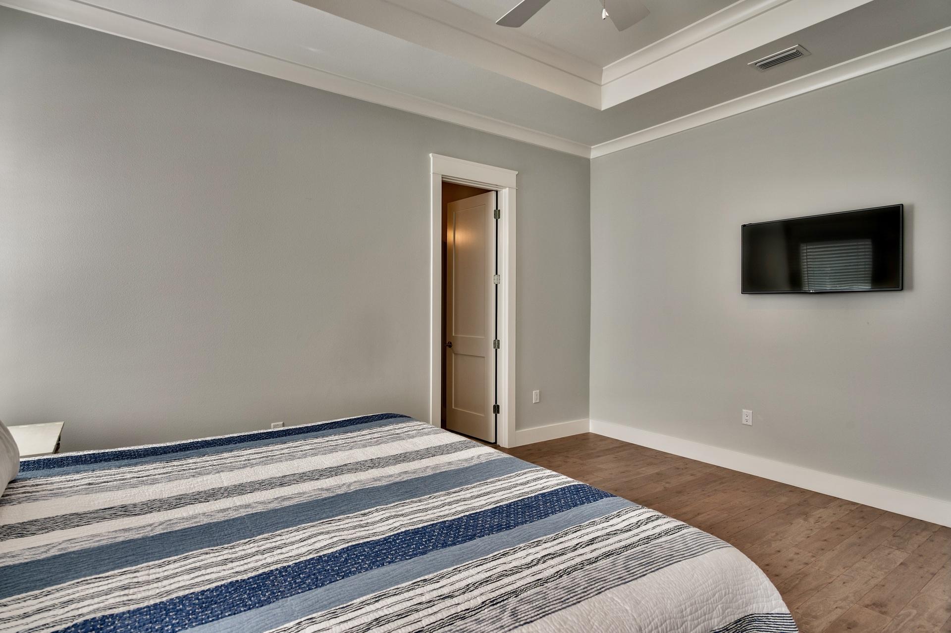 1591 Driftwood Point Road Santa Rosa Beach, FL 32459 - Photo 26 of 50 a bedroom with a bed and a flat screen tv