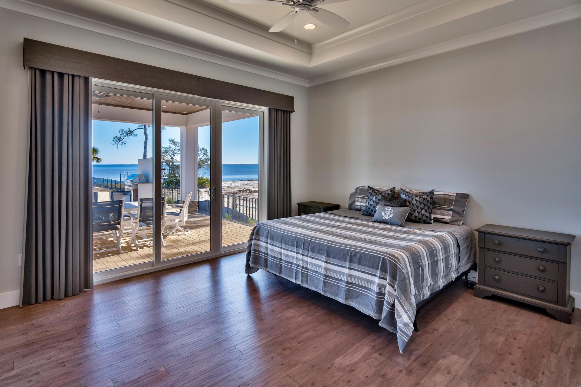 1591 Driftwood Point Road Santa Rosa Beach, FL 32459 - Photo 28 of 50 a bedroom with a bed and wooden floor