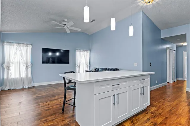 a kitchen with a sink microwave and cabinets