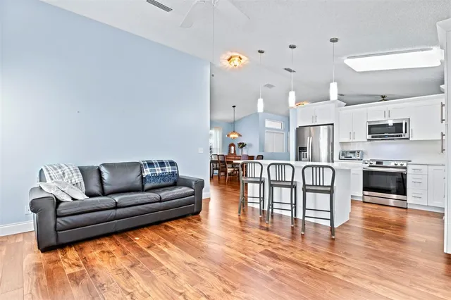 a living room with fireplace furniture and a wooden floor