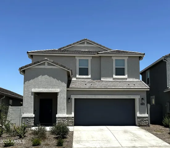 a front view of a house with a garage