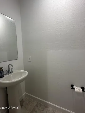 a bathroom with a sink and mirror