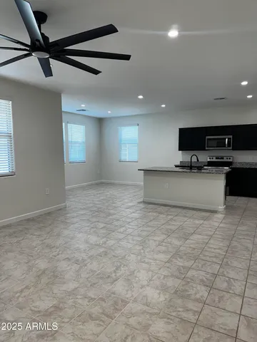 a kitchen with stainless steel appliances granite countertop a sink and a stove
