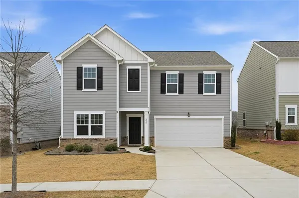 a front view of a house with garage