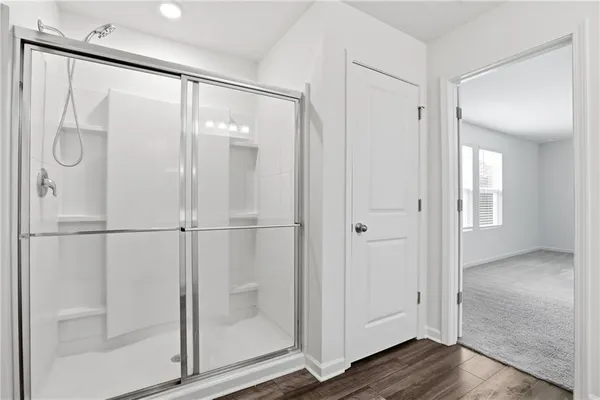 a bathroom with a glass shower door