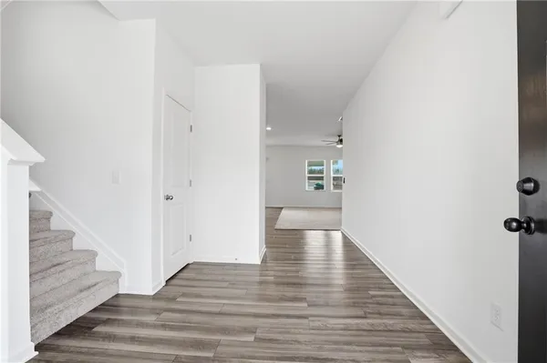 a view of an entryway with wooden floor