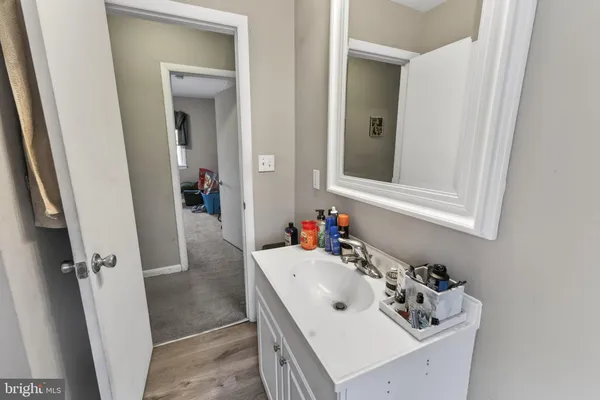 a bedroom with a bed and a flat tv screen on dresser