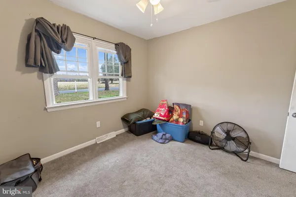a living room with furniture a window and a flat screen tv