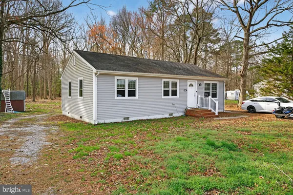 a view of a yard with a house and a tree