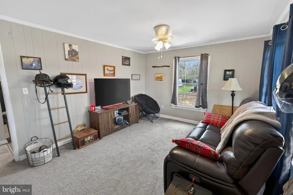 a living room with furniture a flat screen tv and a couch