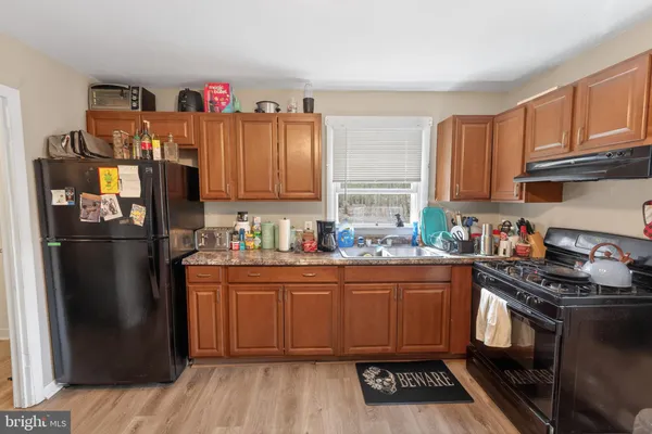 a kitchen with stainless steel appliances granite countertop a refrigerator stove and sink