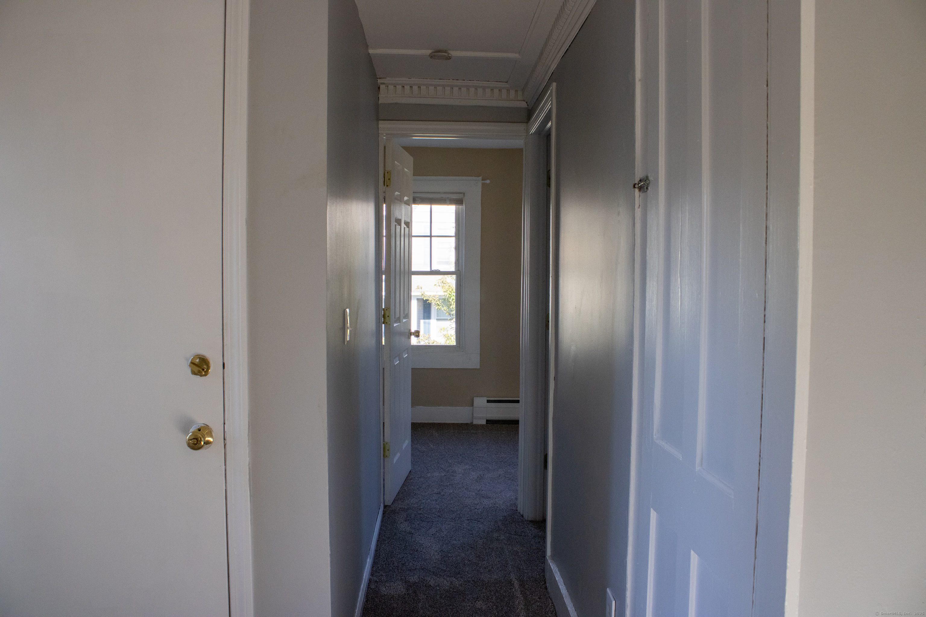 34 Fair Street Wallingford, CT 06492 - Photo 11 of 22 a view of a hallway with wooden floor and a bathroom