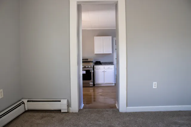 a view of a hallway with kitchen