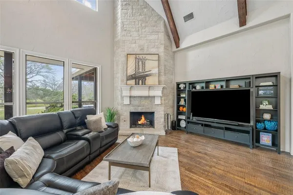 a living room with furniture a fireplace and a flat screen tv