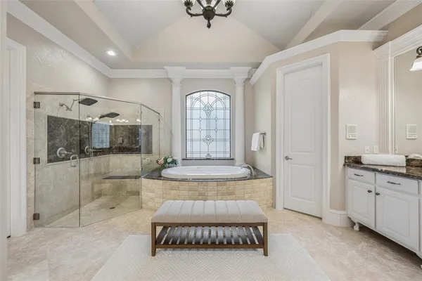 a large bathroom with a granite countertop double vanity and a mirror
