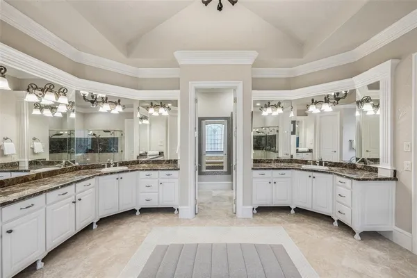 a spacious bathroom with a granite countertop sink and a mirror