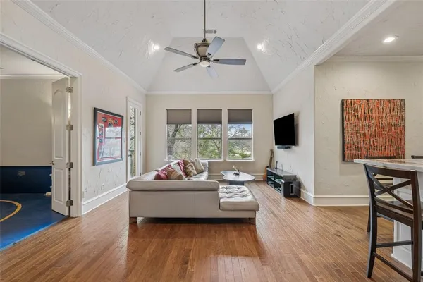 a room with gym equipment and wooden floor