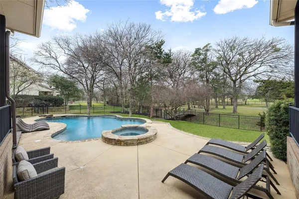 a view of a house with swimming pool and sitting area
