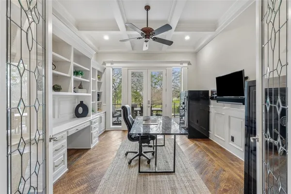 a dining room with furniture a chandelier and wooden floor