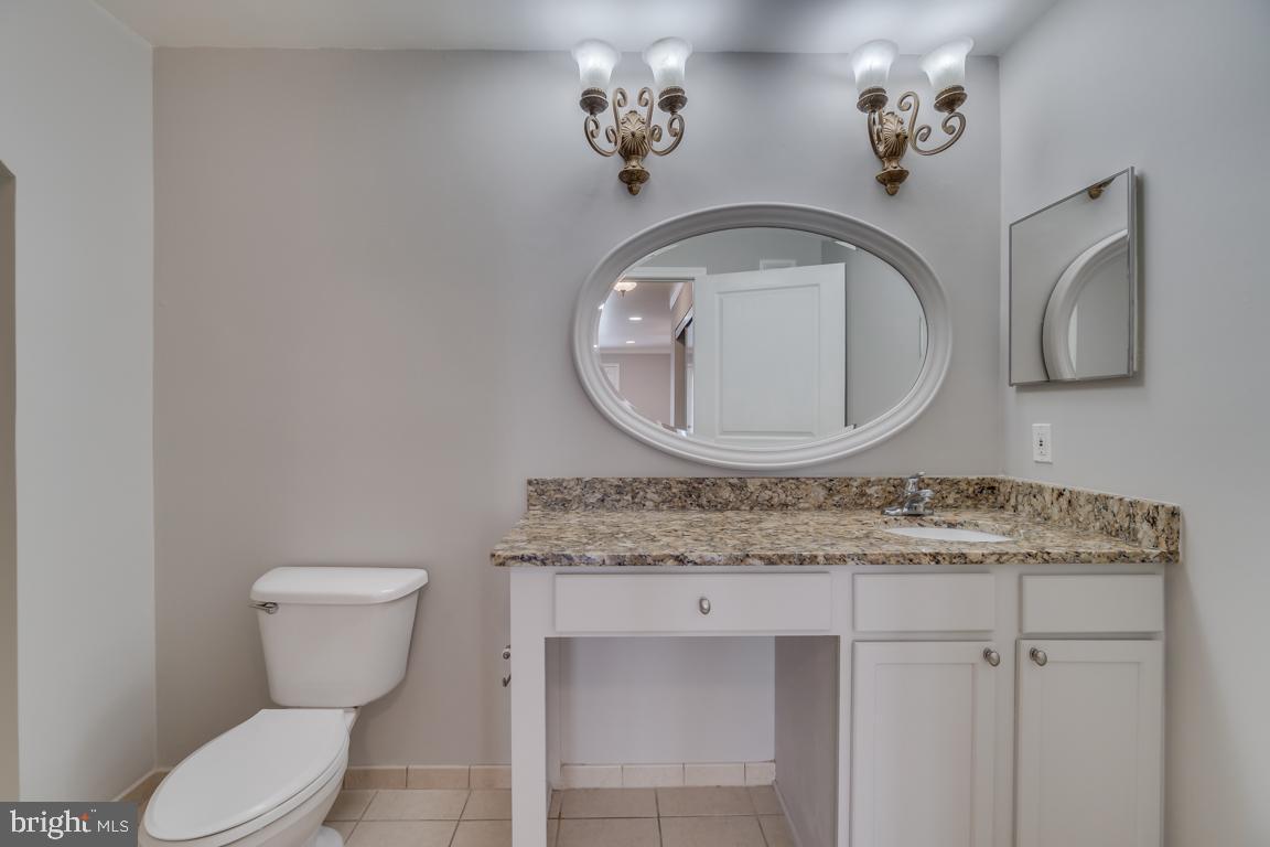 12000 Market Street, Unit 419 Reston, VA 20190 - Photo 20 of 38 Vanity with granite counter top in primary bedroom