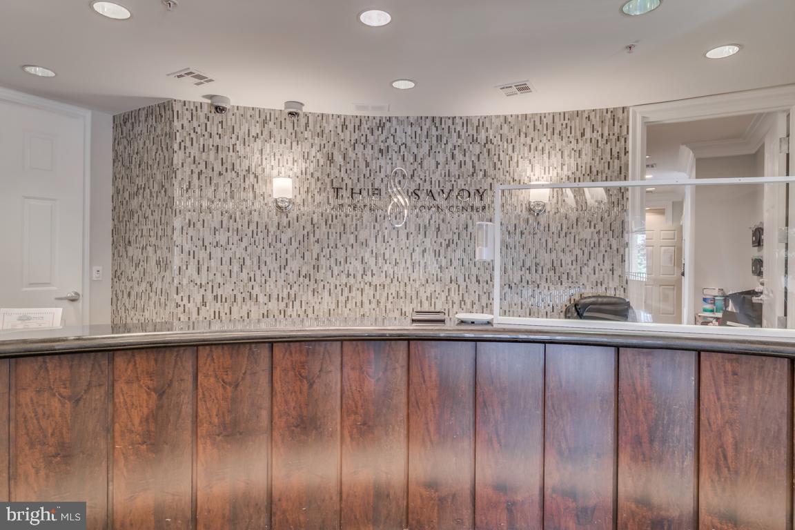 12000 Market Street, Unit 419 Reston, VA 20190 - Photo 4 of 38 Concierge desk in front lobby