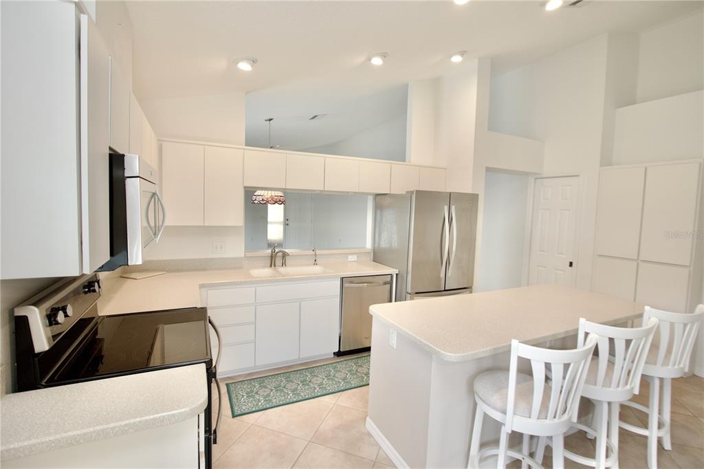 7842 Tenby Court New Port Richey, FL 34655 - Photo 15 of 27 a large white kitchen with a sink and cabinets