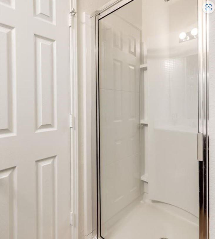 169 Marcheeta Way Leander, TX 78641 - Photo 12 of 30 a bathroom with a glass shower door