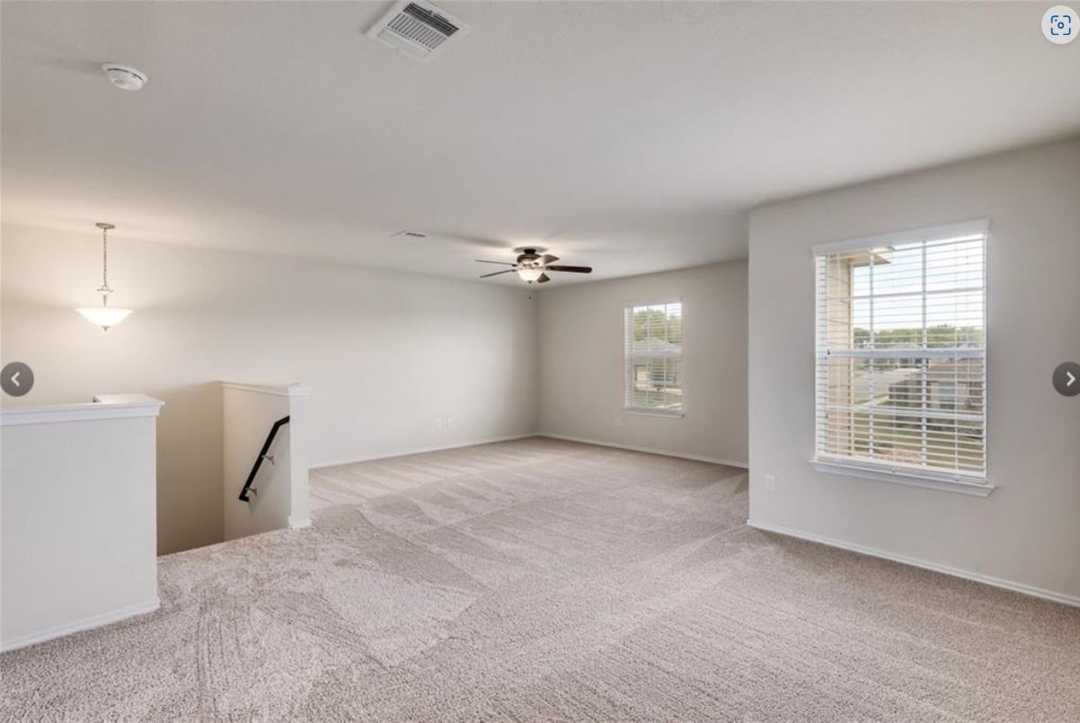 169 Marcheeta Way Leander, TX 78641 - Photo 13 of 30 an empty room with chandelier fan and windows