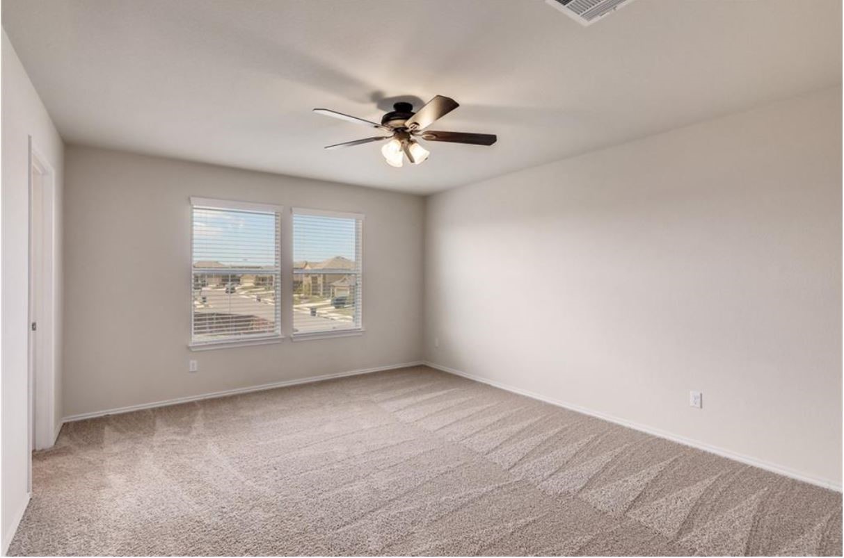 169 Marcheeta Way Leander, TX 78641 - Photo 16 of 30 wooden floor in an empty room with a window