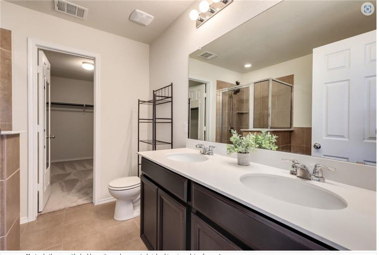 169 Marcheeta Way Leander, TX 78641 - Photo 18 of 30 a bathroom with a double vanity sink toilet and shower