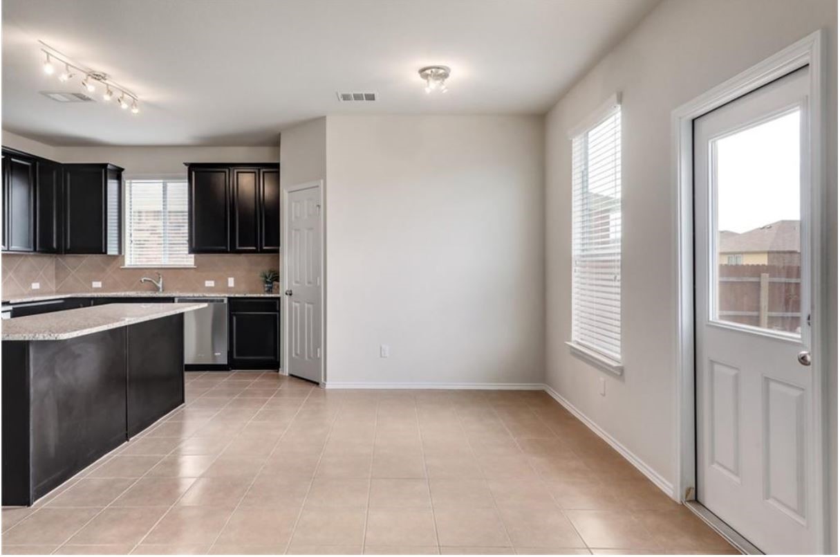 169 Marcheeta Way Leander, TX 78641 - Photo 4 of 30 a kitchen with stainless steel appliances granite countertop a stove a sink and a refrigerator