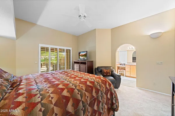 a bedroom with a bed and dresser with mirror