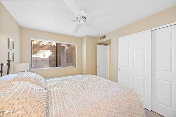 a bedroom with a large bed and a window