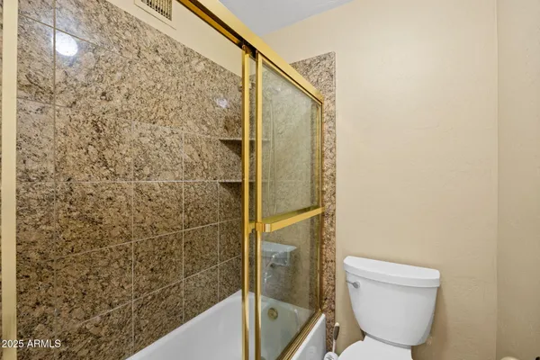 a bathroom with a toilet and shower