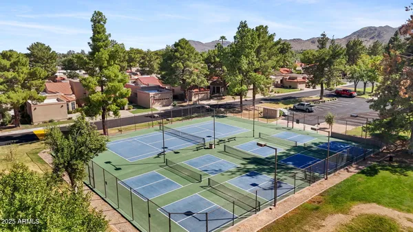 an aerial view of a house with garden space and street view