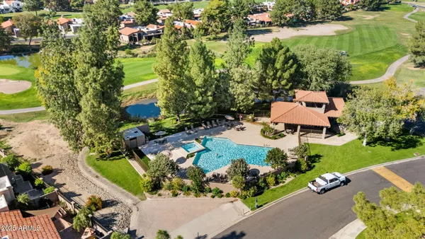 an aerial view of a residential houses with outdoor space and street view