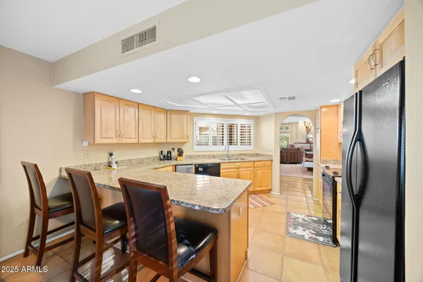 a large kitchen with a table and chairs