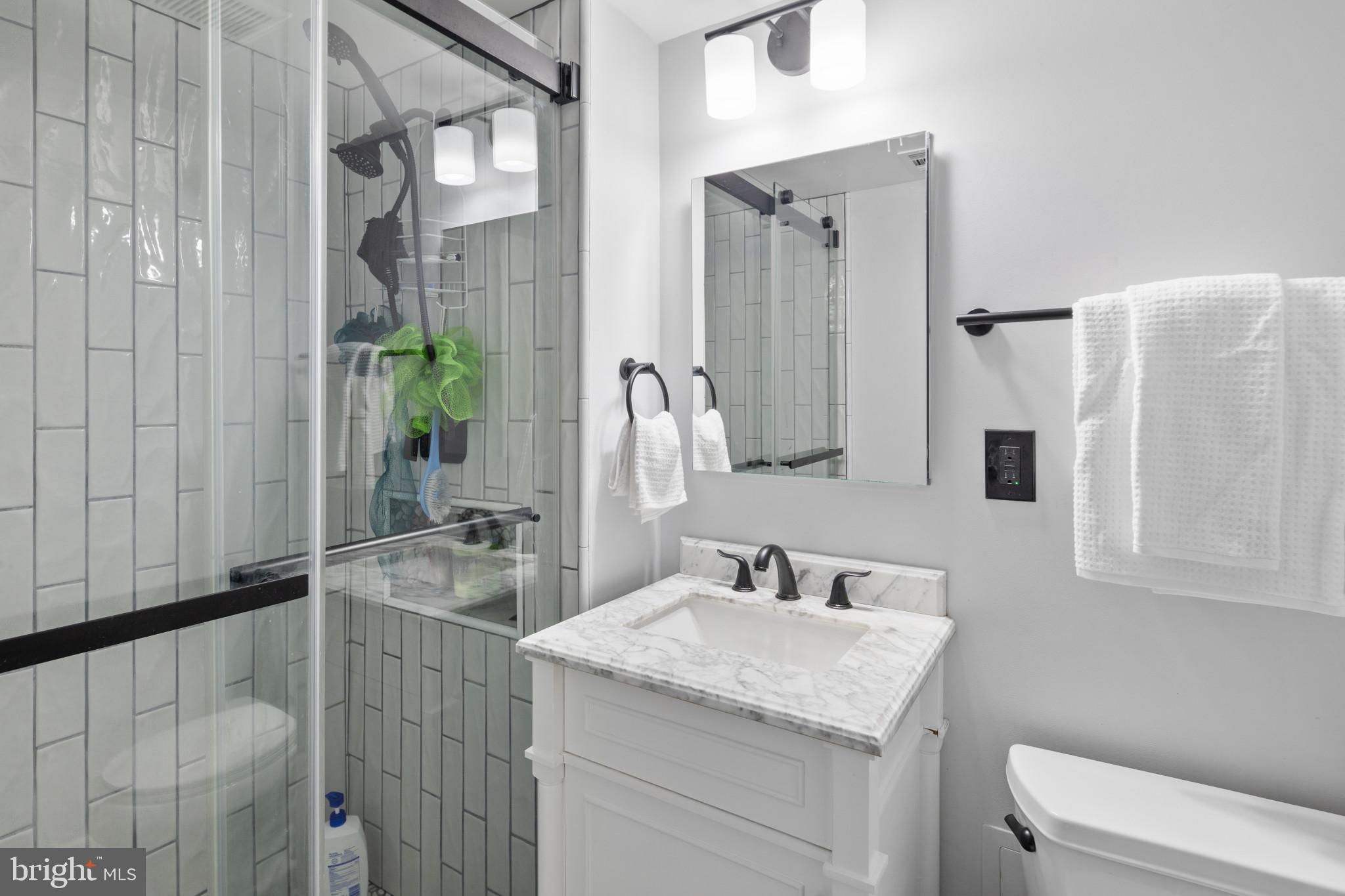 1824 Metzerott Road, Unit B5 Adelphi, MD 20783 - Photo 14 of 25 a bathroom with a granite countertop sink a toilet and shower