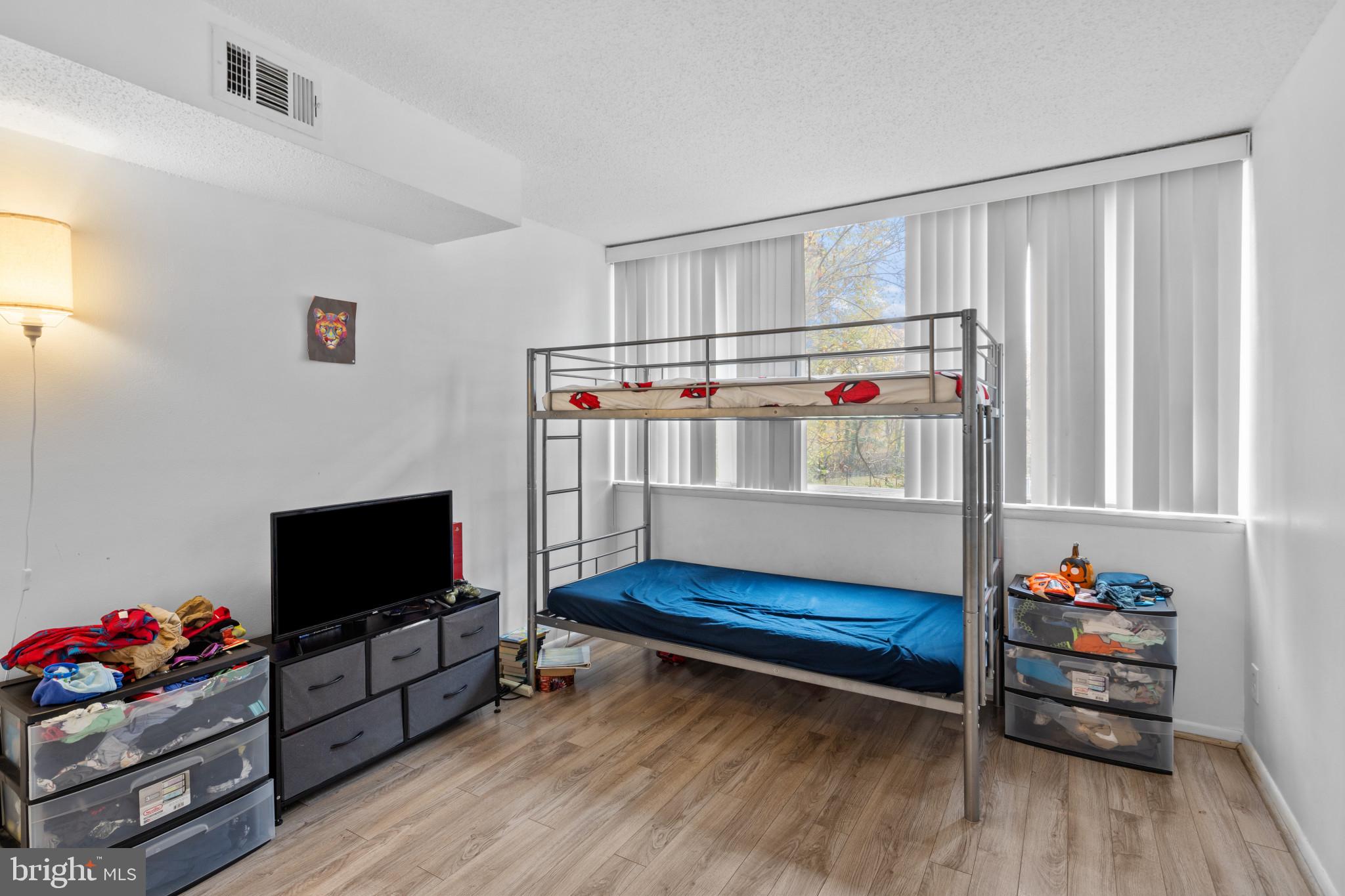 1824 Metzerott Road, Unit B5 Adelphi, MD 20783 - Photo 15 of 25 a bedroom with furniture and a flat screen tv