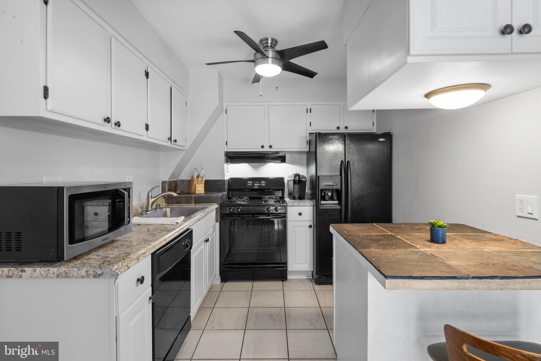 1824 Metzerott Road, Unit B5 Adelphi, MD 20783 - Photo 2 of 25 a kitchen with a stove a refrigerator and a sink