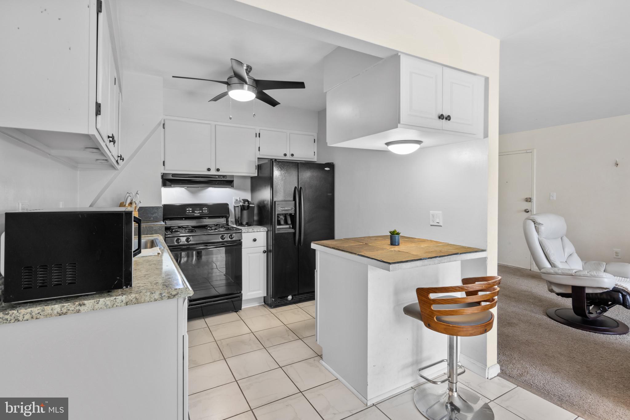 1824 Metzerott Road, Unit B5 Adelphi, MD 20783 - Photo 3 of 25 a kitchen with a stove a refrigerator and cabinetry