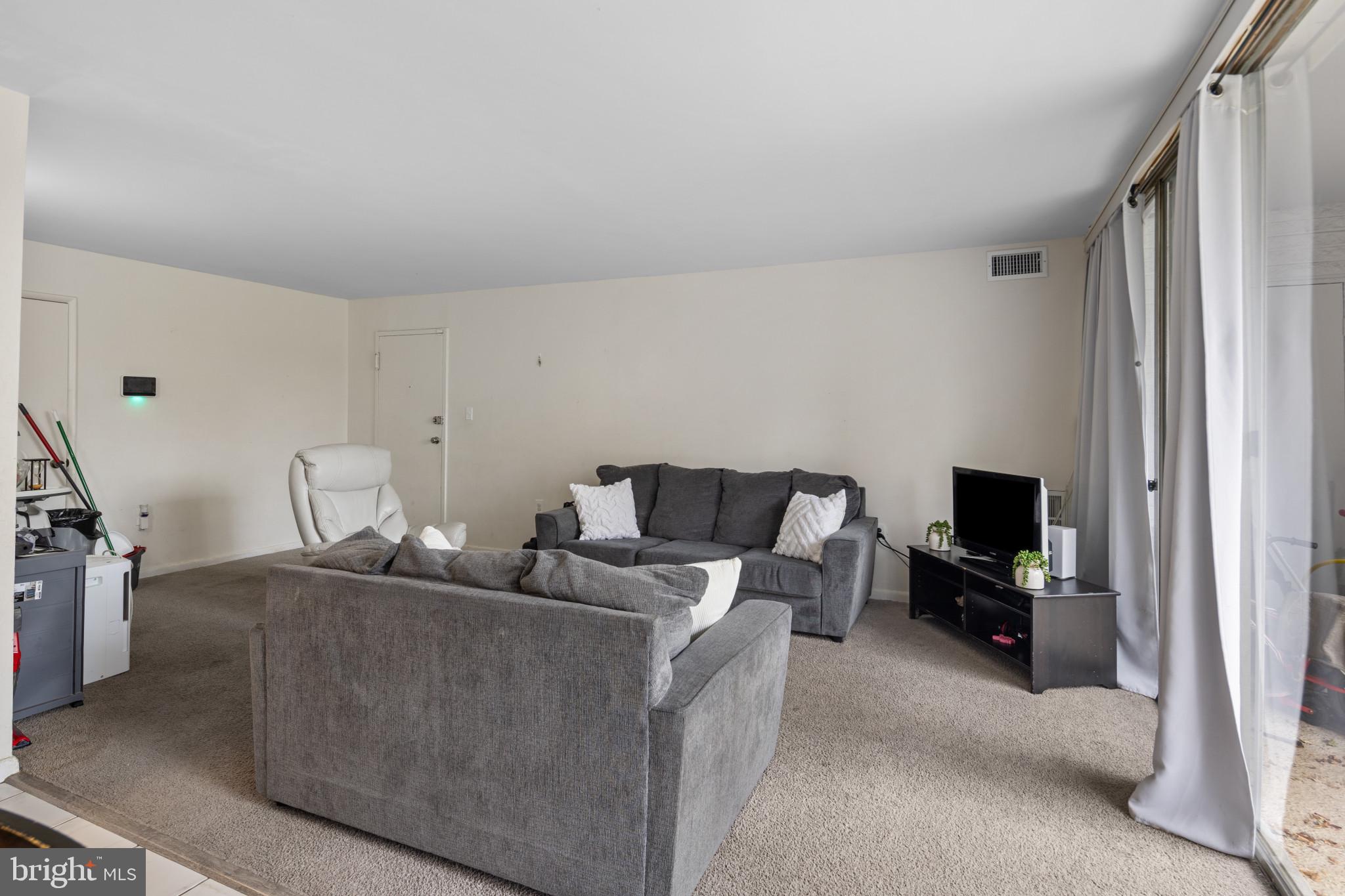 1824 Metzerott Road, Unit B5 Adelphi, MD 20783 - Photo 6 of 25 a living room with furniture and a flat screen tv