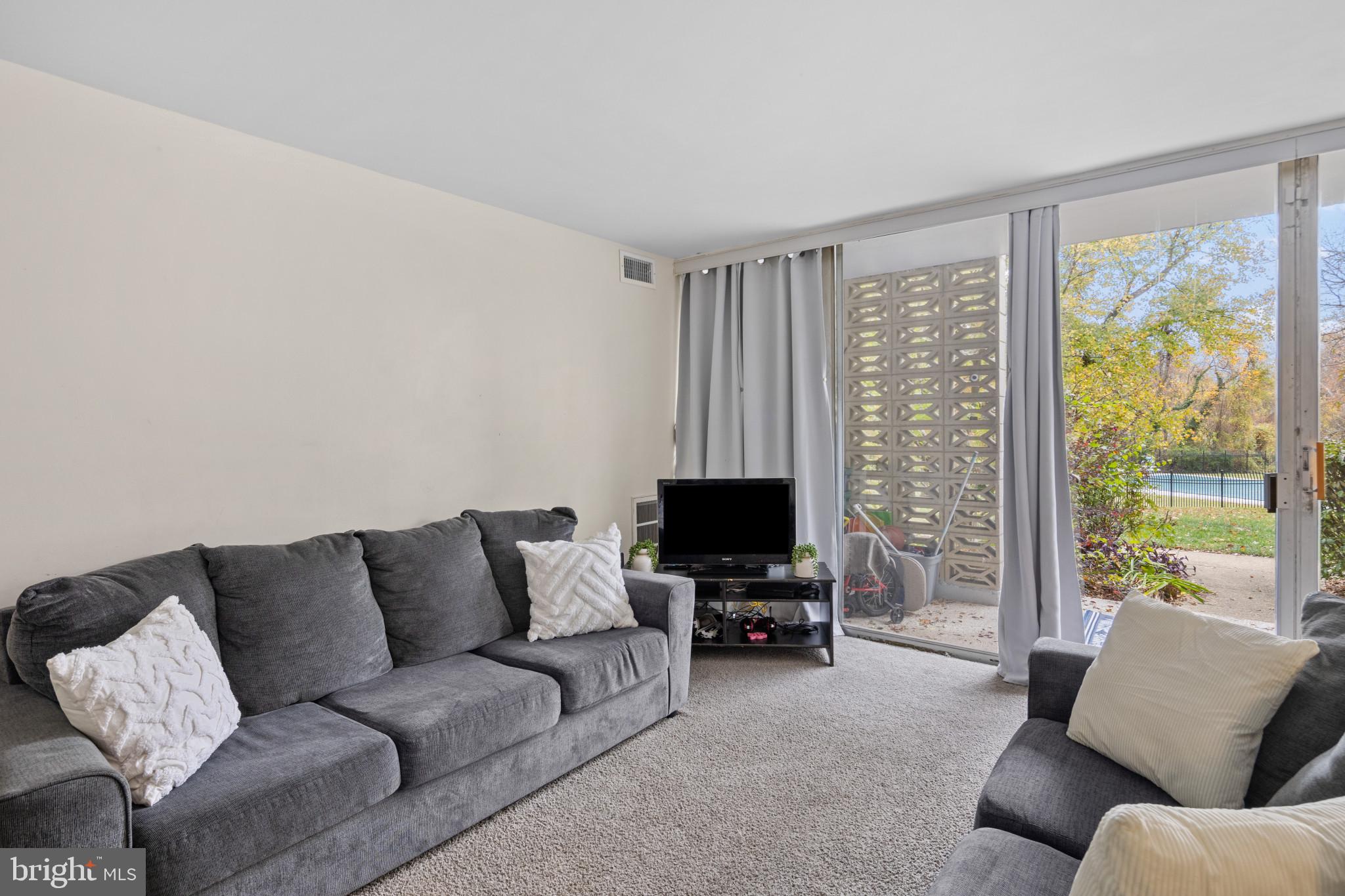 1824 Metzerott Road, Unit B5 Adelphi, MD 20783 - Photo 7 of 25 a living room with furniture and a flat screen tv