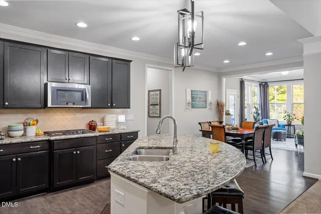 a kitchen with sink table and chairs