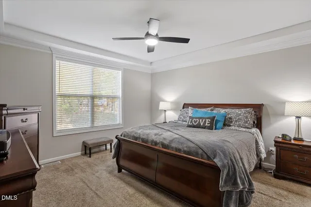a bedroom with a bed a chandelier and a window