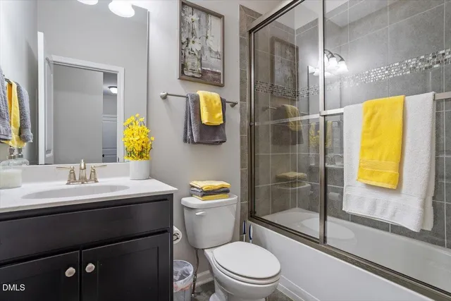 a view of an empty room with wooden floor and windows