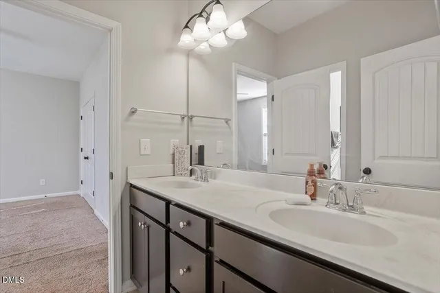 a bedroom with a bed a dresser and a window